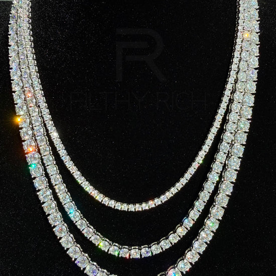 Luxury Moissanite Tennis Necklaces layered on a black velvet display bust showcasing the beautiful sparkle and brilliance shine it gives off in different lighting. 